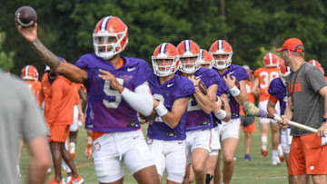 Clemson quarterback D.J. Uiagalelei (5) throws a ball near fellow quarterbacks and Clemson offensive coordinator Brandon Streeter during practice in Clemson Friday, August 12, 2022.Clemson Football Photos From Aug 12 Practice Before Sept 5 Opener