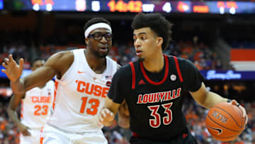 SYRACUSE, NY - FEBRUARY 20: Jordan Nwora #33 of the Louisville Cardinals drives to the basket against the defense of Paschal Chukwu #13 of the Syracuse Orange during the first half at the Carrier Dome on February 20, 2019 in Syracuse, New York. (Photo by Rich Barnes/Getty Images)