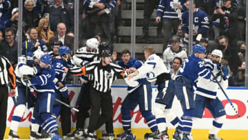 May 2, 2022; Toronto, Ontario, CAN; Referee Dan O'Rourke (9) tries to separate players from the Toronto Maple Leafs and Tampa Bay LIghtning as they engage in a brawl in the third period of game one of the first round of the 2022 Stanley Cup Playoffs at Scotiabank Arena. Mandatory Credit: Dan Hamilton-USA TODAY Sports