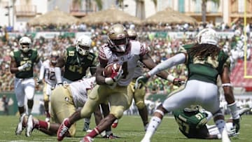 Sep 24, 2016; Tampa, FL, USA; Florida State Seminoles running back Dalvin Cook (4) runs the ball as South Florida Bulls defensive back Johnny Ward (24) defends in the second quarter at Raymond James Stadium. Mandatory Credit: Logan Bowles-USA TODAY Sports