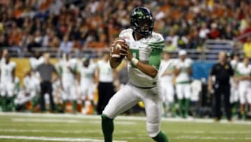 Dec 30, 2013; San Antonio, TX, USA; Oregon Ducks quarterback Marcus Mariota (8) looks to pass during the second half against the Texas Longhorns at Alamo Dome. Oregon defeated Texas 30-7. Mandatory Credit: Soobum Im-USA TODAY Sports