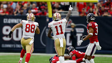 HOUSTON, TX - DECEMBER 10: Garrett Celek #88 of the San Francisco 49ers runs with the ball after a pass as Kareem Jackson #25 of the Houston Texans and Andre Hal #29 pursue at NRG Stadium on December 10, 2017 in Houston, Texas. (Photo by Bob Levey/Getty Images)