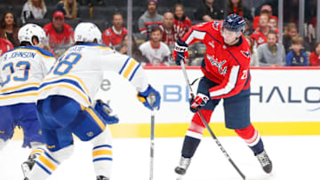 Sep 24, 2023; Washington, District of Columbia, USA; Washington Capitals forward Aliaksei Protas (21) shoots the puck as Buffalo Sabres defenseman Kale Calgue (38) and Sabres defenseman Ryan Johnson (33) defend during the third period at Capital One Arena. Mandatory Credit: Amber Searls-USA TODAY Sports