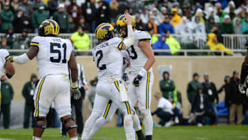 EAST LANSING, MI - OCTOBER 20: Michigan Wolverines quarterback Shea Patterson (2) and tight end Zach Gentry (83) celebrate a fourth quarter touchdown during a Big Ten Conference college football game between Michigan State and Michigan on October 20, 2018, at Spartan Stadium in East Lansing, MI. (Photo by Adam Ruff/Icon Sportswire via Getty Images)