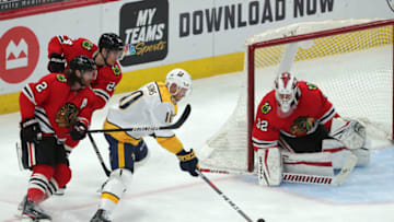 Mar 27, 2021; Chicago, Illinois, USA; Nashville Predators center Colton Sissons (10) moves in on Chicago Blackhawks goaltender Kevin Lankinen (32) during the second period at the United Center. Mandatory Credit: Dennis Wierzbicki-USA TODAY Sports