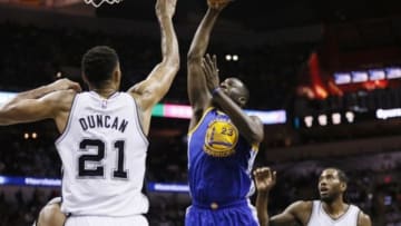 Apr 5, 2015; San Antonio, TX, USA; Golden State Warriors small forward Draymond Green (23) shoots the ball over San Antonio Spurs power forward Tim Duncan (21) during the second half at AT&T Center. Mandatory Credit: Soobum Im-USA TODAY Sports