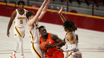 Feb 20, 2021; Minneapolis, Minnesota, USA; Illinois Fighting Illini center Kofi Cockburn (21) in action while Minnesota Golden Gophers center Liam Robbins (0) and forward Brandon Johnson (23) defend in the first half at Williams Arena. Mandatory Credit: David Berding-USA TODAY Sports