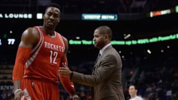 Feb 4, 2016; Phoenix, AZ, USA; Houston Rockets center Dwight Howard (12) and head coach J.B. Bickerstaff interact at Talking Stick Resort Arena. Mandatory Credit: Jennifer Stewart-USA TODAY Sports