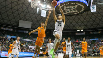 HONOLULU, HI - DECEMBER 22: Samuta Avea #32 of the Hawaii Rainbow Warriors lays the ball in ahead of Tydus Verhoeven #1 of the UTEP Miners during the second half of the game at the Stan Sheriff Center on December 22, 2019 in Honolulu, Hawaii. (Photo by Darryl Oumi/Getty Images)