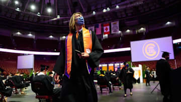 Clemson's Trevor Lawrence walks to his seat before his commencement ceremony at the Bon Secours Wellness Arena Thursday, Dec. 17, 2020.Jm Clemson 121720 002