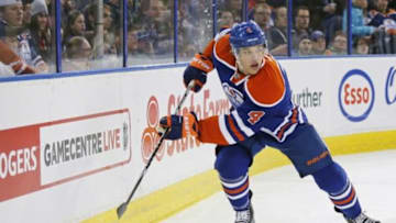 Dec 1, 2014; Edmonton, Alberta, CAN; Edmonton Oilers forward Taylor Hall (4) chases a loose puck during the second period against the Arizona Coyotes at Rexall Place. Mandatory Credit: Perry Nelson-USA TODAY Sports