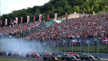 BUDAPEST, HUNGARY - AUGUST 04: Max Verstappen of the Netherlands driving the (33) Aston Martin Red Bull Racing RB15, Valtteri Bottas driving the (77) Mercedes AMG Petronas F1 Team Mercedes W10 and Lewis Hamilton of Great Britain driving the (44) Mercedes AMG Petronas F1 Team Mercedes W10 battle for position into turn one at the start during the F1 Grand Prix of Hungary at Hungaroring on August 04, 2019 in Budapest, Hungary. (Photo by Charles Coates/Getty Images)