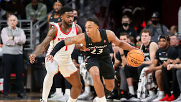 Cincinnati Bearcats guard Mika Adams-Woods dribbles the ball against Houston Cougars guard Jamal Shead at Fifth Third Arena. Getty Images.