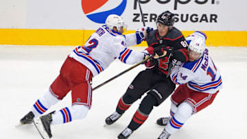 TORONTO, ONTARIO - AUGUST 01: Martin Necas #88 of the Carolina Hurricanes attempts to get past Brendan Smith #42 and Greg McKegg #14 of the New York Rangers during the first period in Game One of the Eastern Conference Qualification Round prior to the 2020 NHL Stanley Cup Playoffs at Scotiabank Arena on August 1, 2020 in Toronto, Ontario, Canada. (Photo by Andre Ringuette/Getty Images)