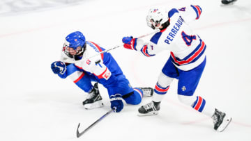 BASEL, SWITZERLAND - APRIL 29: Gabe Perreault of United States (R) shots is blocked by Jakub Chromiak of Slovakia during the semi final of U18 Ice Hockey World Championship match between United States and Slovakia at St. Jakob-Park on April 29, 2023 in Basel, Switzerland. (Photo by Jari Pestelacci/Eurasia Sport Images/Getty Images)