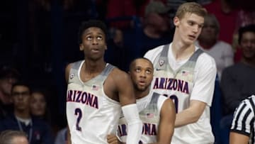 Nov 21, 2016; Tucson, AZ, USA; Arizona Wildcats guard Kobi Simmons (2) guard Parker Jackson-Cartwright (0) (middle) and forward Lauri Markkanen (10) (right) look to the video board during the second half against the Northern Colorado Bears at McKale Center. Arizona won 71-55. Mandatory Credit: Casey Sapio-USA TODAY Sports