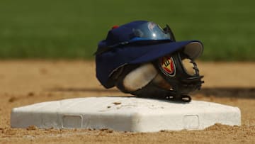 CHICAGO - JUNE 30: General view of a baseball glove and cap on top of a base during the game between the Houston Astros and the Chicago Cubs at Wrigley Field on June 30, 2004 in Chicago, Illinois. The Astros defeated the Cubs 3-2. (Photo by Jonathan Daniel/Getty Images)