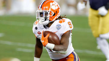 CHARLOTTE, NORTH CAROLINA - DECEMBER 19: Running back Travis Etienne #9 of the Clemson Tigers runs on his way to scoring a 44-yard touchdown in the second quarter against the Notre Dame Fighting Irish during the ACC Championship game at Bank of America Stadium on December 19, 2020 in Charlotte, North Carolina. (Photo by Jared C. Tilton/Getty Images)