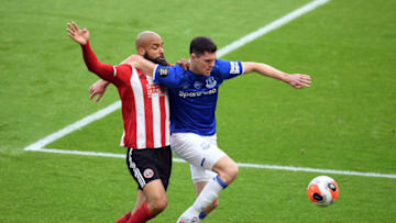 SHEFFIELD, ENGLAND - JULY 20: Michael Keane of Everton battles for possession with David McGoldrick of Sheffield United during the Premier League match between Sheffield United and Everton FC at Bramall Lane on July 20, 2020 in Sheffield, England. Football Stadiums around Europe remain empty due to the Coronavirus Pandemic as Government social distancing laws prohibit fans inside venues resulting in all fixtures being played behind closed doors. (Photo by Michael Regan/Getty Images)