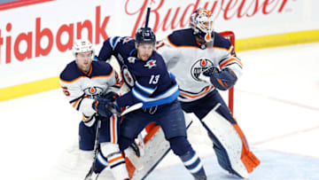 Apr 17, 2021; Winnipeg, Manitoba, CAN; Edmonton Oilers right wing Kailer Yamamoto (56) and Winnipeg Jets left wing Pierre-Luc Dubois (13) tangle in front of Edmonton Oilers goaltender Mike Smith (41) in the first period at Bell MTS Place. Mandatory Credit: James Carey Lauder-USA TODAY Sports