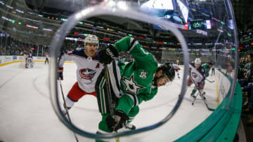 DALLAS, TX - JANUARY 02: Columbus Blue Jackets center Boone Jenner (38) cross checks Dallas Stars center Devin Shore (17) into the boards during the game between the Dallas Stars and the Columbus Blue Jackets on January 02, 2018 at the American Airlines Center in Dallas, Texas. Columbus defeats Dallas 2-1. (Photo by Matthew Pearce/Icon Sportswire via Getty Images)