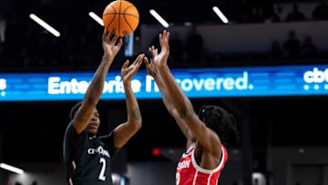 Cincinnati Bearcats guard Landers Nolley II hits shot over Houston Cougars guard Tramon Mark at Fifth Third Arena. The Enquirer.