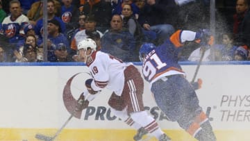 Feb 24, 2015; Uniondale, NY, USA; Arizona Coyotes right wing Shane Doan (19) keeps the puck from New York Islanders center John Tavares (91) during the third period at Nassau Veterans Memorial Coliseum. New York Islanders won 5-1. Mandatory Credit: Anthony Gruppuso-USA TODAY Sports
