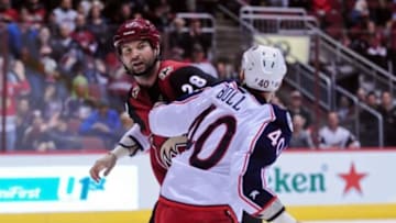 Dec 17, 2015; Glendale, AZ, USA; Arizona Coyotes left wing John Scott (28) and Columbus Blue Jackets right wing Jared Boll (40) fight during the second period at Gila River Arena. Mandatory Credit: Matt Kartozian-USA TODAY Sports