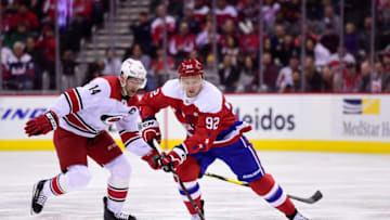 WASHINGTON, DC - MARCH 26: Evgeny Kuznetsov #92 of the Washington Capitals skates with the puck against Justin Williams #14 of the Carolina Hurricanes in the first period at Capital One Arena on March 26, 2019 in Washington, DC. (Photo by Patrick McDermott/NHLI via Getty Images)
