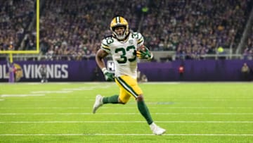 MINNEAPOLIS, MN - NOVEMBER 25: Aaron Jones #33 of the Green Bay Packers runs with the ball for a six-yard touchdown in the second quarter of the game against the Minnesota Vikings at U.S. Bank Stadium on November 25, 2018 in Minneapolis, Minnesota. (Photo by Adam Bettcher/Getty Images)