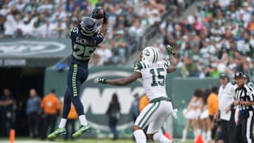 Oct 2, 2016; East Rutherford, NJ, USA; Seattle Seahawks cornerback Richard Sherman (25) intercepts a pass in front of New York Jets wide receiver Brandon Marshall (15) in the second half at MetLife Stadium. Seattle Seahawks defeat the New York Jets 27-17. Mandatory Credit: William Hauser-USA TODAY Sports