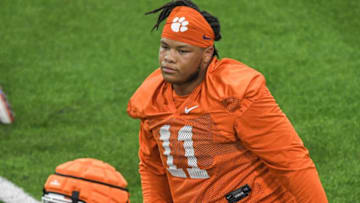 Clemson defensive lineman Peter Woods (11) stretches during preseason practice at the Poe Indoor Practice Facility at the Allen N. Reeves football complex in Clemson, S.C. Monday, August 7, 2023.