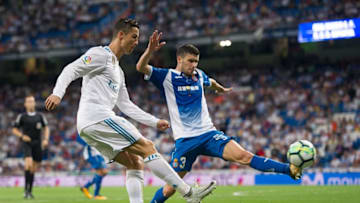 MADRID, SPAIN - OCTOBER 01: Cristiano Ronaldo of Real Madrid CF shoots past Aaron Martin of RCD Espanyolduring the La Liga match between Real Madrid and Espanyol at Estadio Santiago Bernabeu on October 1, 2017 in Madrid, Spain. (Photo by Denis Doyle/Getty Images)