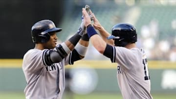 Jun 6, 2013; Seattle, WA, USA; New York Yankees second baseman Robinson Cano (left) and shortstop Jayson Nix (right) high five at home plate after Cano hit a 3-run home run against the Seattle Mariners during the 3rd inning at Safeco Field. Mandatory Credit: Steven Bisig-USA TODAY Sports