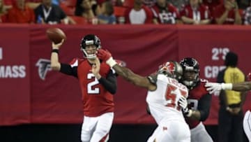 Sep 18, 2014; Atlanta, GA, USA; Atlanta Falcons quarterback Matt Ryan (2) attempts a pass as Tampa Bay Buccaneers defensive end Larry English (57) defends as Atlanta Falcons guard Justin Blalock (63) blocks in the second quarter of their game at the Georgia Dome. Mandatory Credit: Jason Getz-USA TODAY Sports