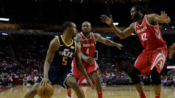 HOUSTON, TX - NOVEMBER 05: Rodney Hood #5 of the Utah Jazz controls the ball defended by PJ Tucker #4 and Nene Hilario #42 of the Houston Rockets in the first half at Toyota Center on November 05, 2017 in Houston, Texas. NOTE TO USER: User expressly acknowledges and agrees that, by downloading and or using this photograph, User is consenting to the terms and conditions of the Getty Images License Agreement. (Photo by Tim Warner/Getty Images)