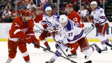 Mar 4, 2015; Detroit, MI, USA; Detroit Red Wings left wing Tomas Tatar (21) and New York Rangers defenseman Ryan McDonagh (27) battle for the puck in the third period at Joe Louis Arena. Detroit won 2-1 in overtime. Mandatory Credit: Rick Osentoski-USA TODAY Sports