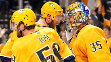 NASHVILLE, TN - DECEMBER 14: Mattias Ekholm #14 congratulates Pekka Rinne #35 of the Nashville Predators on a 3-2 win against the Arizona Coyotes at Bridgestone Arena on December 14, 2019 in Nashville, Tennessee. (Photo by John Russell/NHLI via Getty Images)