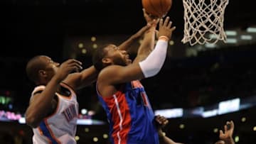 Apr 16, 2014; Oklahoma City, OK, USA; Detroit Pistons forward Greg Monroe (10) attempts a shot against Oklahoma City Thunder forward Serge Ibaka (9) during the first quarter at Chesapeake Energy Arena. Mandatory Credit: Mark D. Smith-USA TODAY Sports