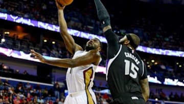 Mar 27, 2015; New Orleans, LA, USA; New Orleans Pelicans guard Tyreke Evans (1) shoots over Sacramento Kings center DeMarcus Cousins (15) during the first quarter of a game at the Smoothie King Center. Mandatory Credit: Derick E. Hingle-USA TODAY Sports