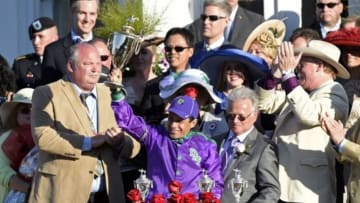 May 3, 2014; Louisville, KY, USA; California Chrome jockey Victor Espinoza (middle) celebrates in the winner