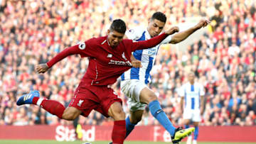 LIVERPOOL, ENGLAND - AUGUST 25: Roberto Firmino of Liverpool is held by his shirt by Leon Balogun of Brighton and Hove Albion during the Premier League match between Liverpool FC and Brighton & Hove Albion at Anfield on August 25, 2018 in Liverpool, United Kingdom. (Photo by Jan Kruger/Getty Images)