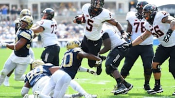 PITTSBURGH, PA - SEPTEMBER 16: Justice Hill #5 of the Oklahoma State Cowboys gets tripped up by Dennis Briggs #20 of the Pittsburgh Panthers during the second quarter at Heinz Field on September 16, 2017 in Pittsburgh, Pennsylvania. (Photo by Joe Sargent/Getty Images)