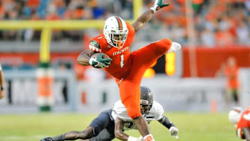 Sep 5, 2015; Miami Gardens, FL, USA; Miami Hurricanes defensive back Artie Burns (1) leaps over Bethune Cookman Wildcats defensive back Austin Walker (35) during the first half at Sun Life Stadium. Mandatory Credit: Steve Mitchell-USA TODAY Sports
