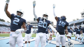 CHAPEL HILL, NC - OCTOBER 10: Dyami Brown #2 Tony Grimes #20, and Dae Dae Hollins #15 of North Carolina lead the fans in the team"u2019s fourth quarter chant during a game between Virginia Tech and North Carolina at Kenan Memorial Stadium on October 10, 2020 in Chapel Hill, North Carolina. (Photo by Andy Mead/ISI Photos/Getty Images)