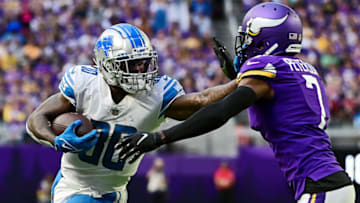 MINNEAPOLIS, MINNESOTA - SEPTEMBER 25: Running back Jamaal Williams #30 of the Detroit Lions fights his way with cornerback Patrick Peterson #7 of the Minnesota Vikings into the end zone for a touchdown in the third quarter of the game at U.S. Bank Stadium on September 25, 2022 in Minneapolis, Minnesota. (Photo by Stephen Maturen/Getty Images)