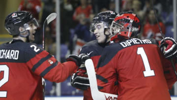 VICTORIA , BC - DECEMBER 19: Michael DiPietro #1, Nick Suzuki #17 and Evan Bouchard #2 of Team Canada celebrate their 5-3 victory versus Team Switzerland at the IIHF World Junior Championships at the Save-on-Foods Memorial Centre on December 19, 2018 in Victoria, British Columbia, Canada. (Photo by Kevin Light/Getty Images)
