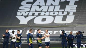 Tottenham Hotspur's English striker Harry Kane (C) and teammates gesture to fans refusing to leave after the English Premier League football match between Tottenham Hotspur and Aston Villa at Tottenham Hotspur Stadium in London, on May 19, 2021. - - RESTRICTED TO EDITORIAL USE. No use with unauthorized audio, video, data, fixture lists, club/league logos or 'live' services. Online in-match use limited to 120 images. An additional 40 images may be used in extra time. No video emulation. Social media in-match use limited to 120 images. An additional 40 images may be used in extra time. No use in betting publications, games or single club/league/player publications. (Photo by DANIEL LEAL-OLIVAS / POOL / AFP) / RESTRICTED TO EDITORIAL USE. No use with unauthorized audio, video, data, fixture lists, club/league logos or 'live' services. Online in-match use limited to 120 images. An additional 40 images may be used in extra time. No video emulation. Social media in-match use limited to 120 images. An additional 40 images may be used in extra time. No use in betting publications, games or single club/league/player publications. / RESTRICTED TO EDITORIAL USE. No use with unauthorized audio, video, data, fixture lists, club/league logos or 'live' services. Online in-match use limited to 120 images. An additional 40 images may be used in extra time. No video emulation. Social media in-match use limited to 120 images. An additional 40 images may be used in extra time. No use in betting publications, games or single club/league/player publications. (Photo by DANIEL LEAL-OLIVAS/POOL/AFP via Getty Images)
