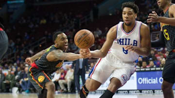 Feb 3, 2016; Philadelphia, PA, USA; Atlanta Hawks guard Jeff Teague (0) knocks the ball from Philadelphia 76ers center Jahlil Okafor (8) during the first quarter at Wells Fargo Center. Mandatory Credit: Bill Streicher-USA TODAY Sports