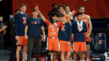 Jan 29, 2021; Champaign, Illinois, USA; Illinois Fighting Illini guard Andre Curbelo (5) and guard Tyler Underwood (middle right) celebrate on the bench during the second half against the Iowa Hawkeyes at the State Farm Center. Mandatory Credit: Patrick Gorski-USA TODAY Sports